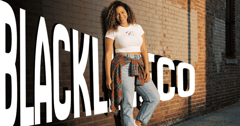 Plus size woman wearing a 90s-inspired outfit with mom jeans, cropped tee, and flannel