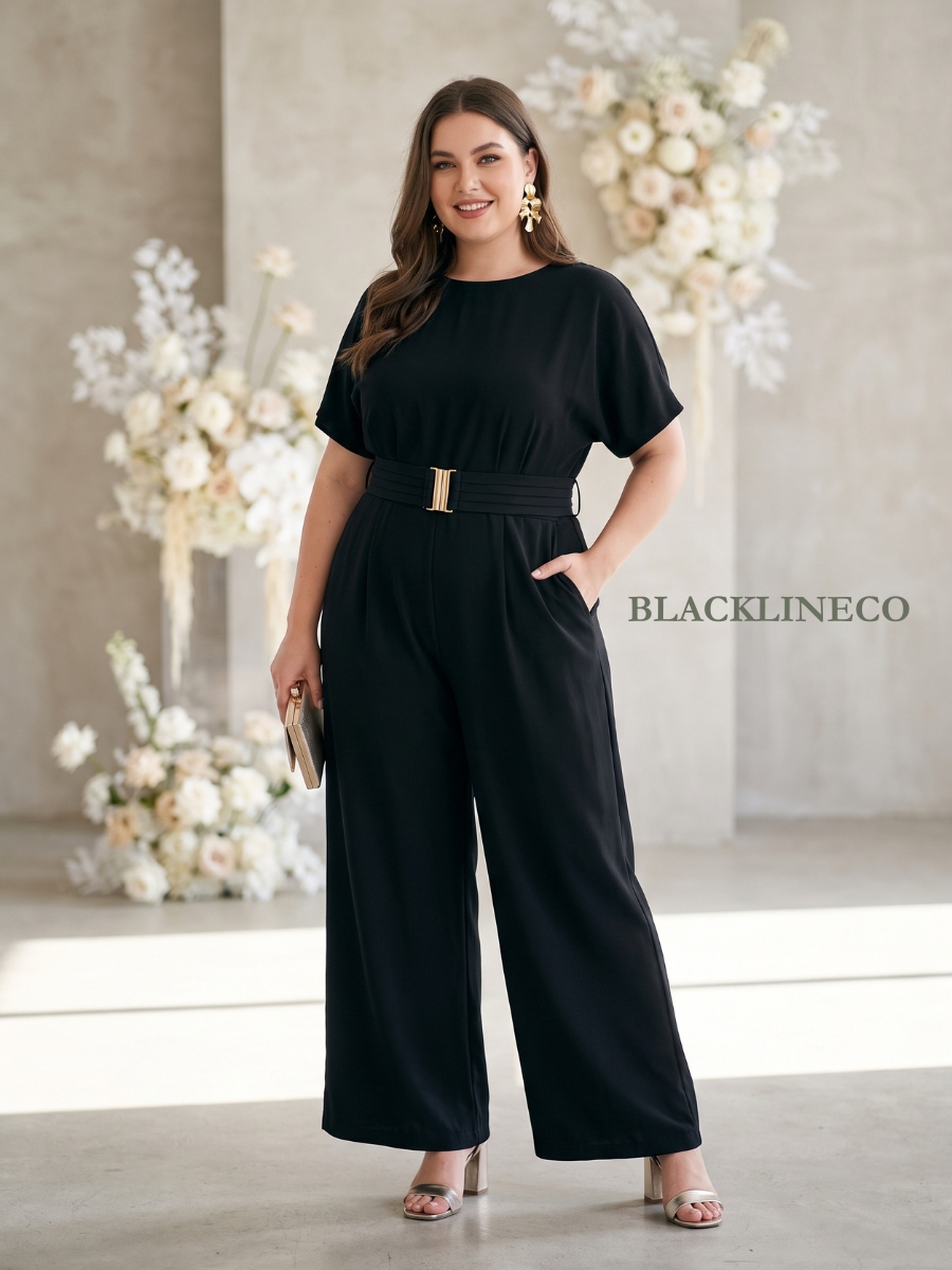 Plus size woman in a black wide-leg jumpsuit with a gold belt at a modern wedding