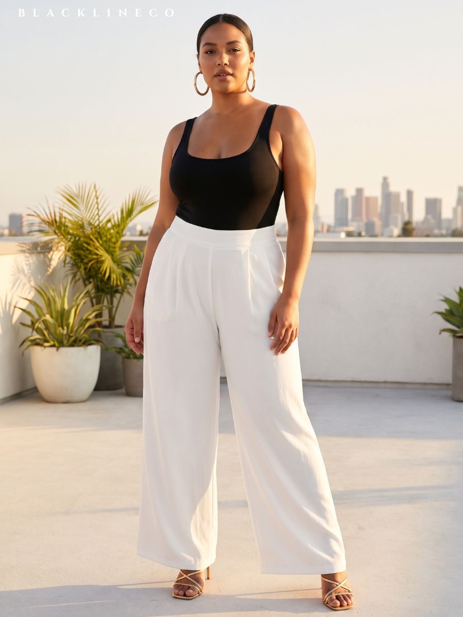 Curvy woman wearing a black fitted bodysuit and high-waisted white palazzo pants